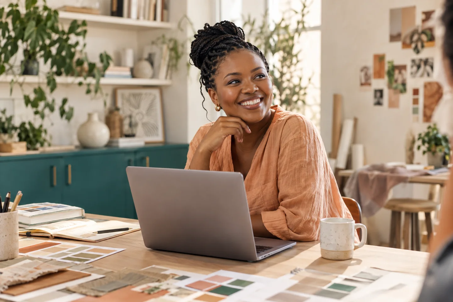 Illustrative creative business owner enjoying a moment in her sunlit studio